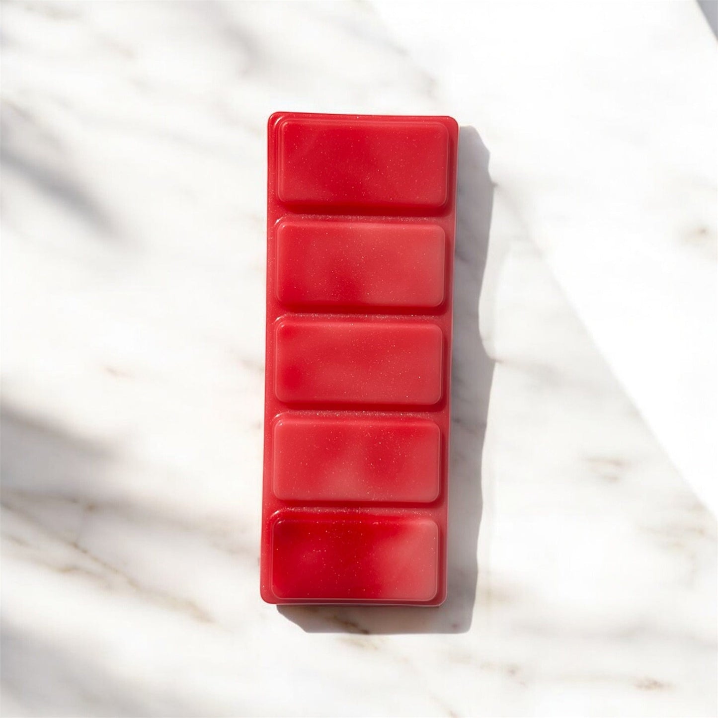 Red wax melt mold on a marble surface c called booty call
