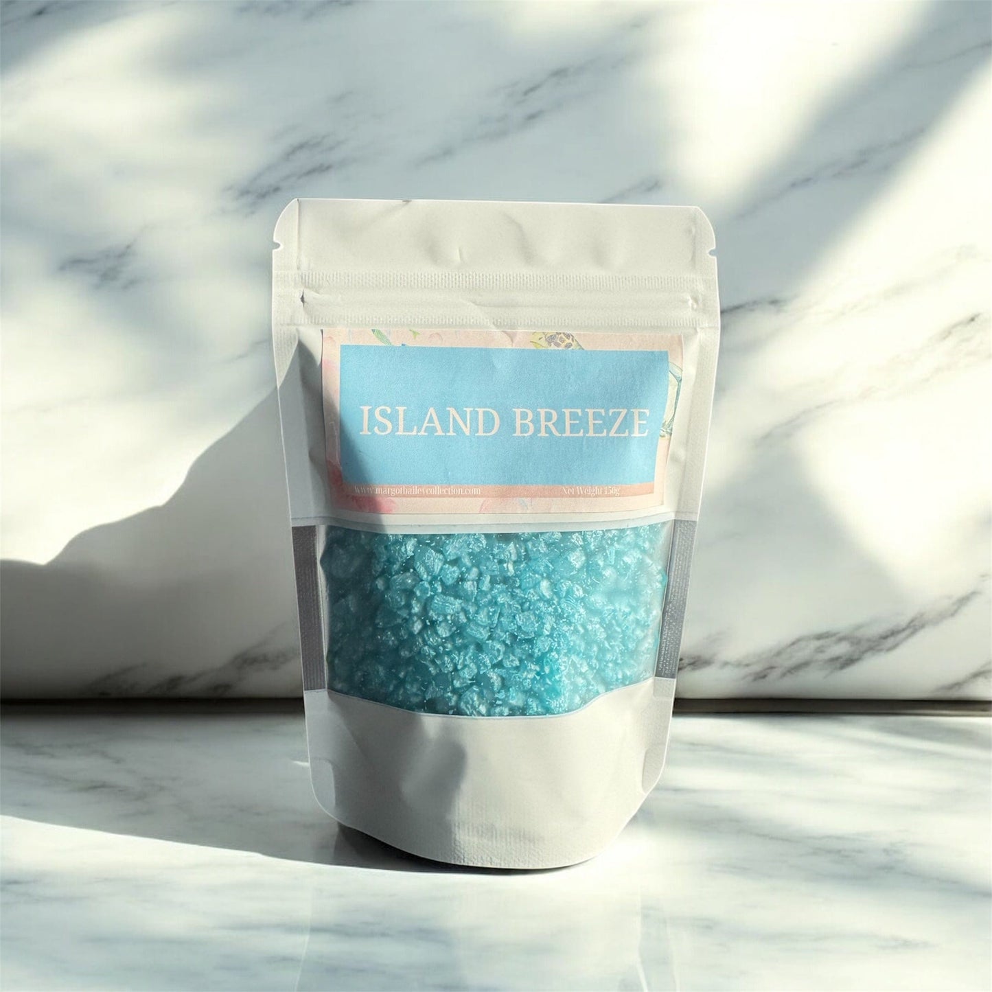 Island Breeze scented crystals by Margot Bailey Collection in resealable pouches, featuring a tropical-inspired fragrance with sweet orange, coconut, jasmine, vanilla, and golden amber.