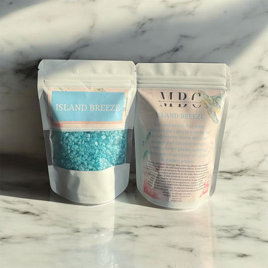 Island Breeze scented crystals by Margot Bailey Collection in resealable pouches, featuring a tropical-inspired fragrance with sweet orange, coconut, jasmine, vanilla, and golden amber.