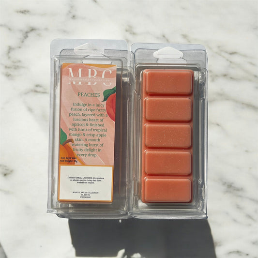 Packaged wax melts with a label on a marble background peaches 