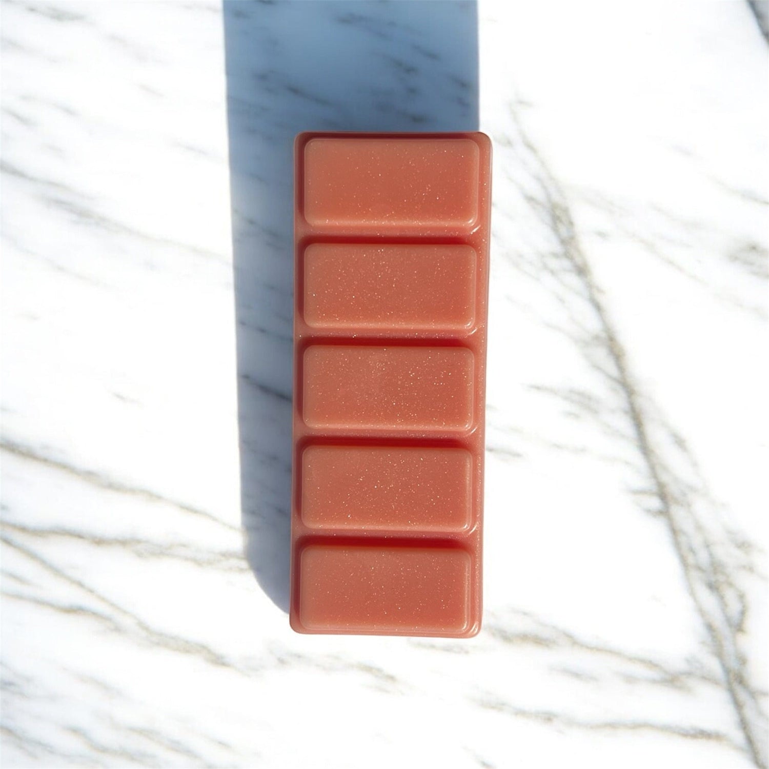 Rectangular wax melt with five compartments on a marble surface peaches